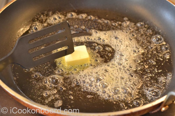Heat cooking oil and butter on a large non-stick frying pan.